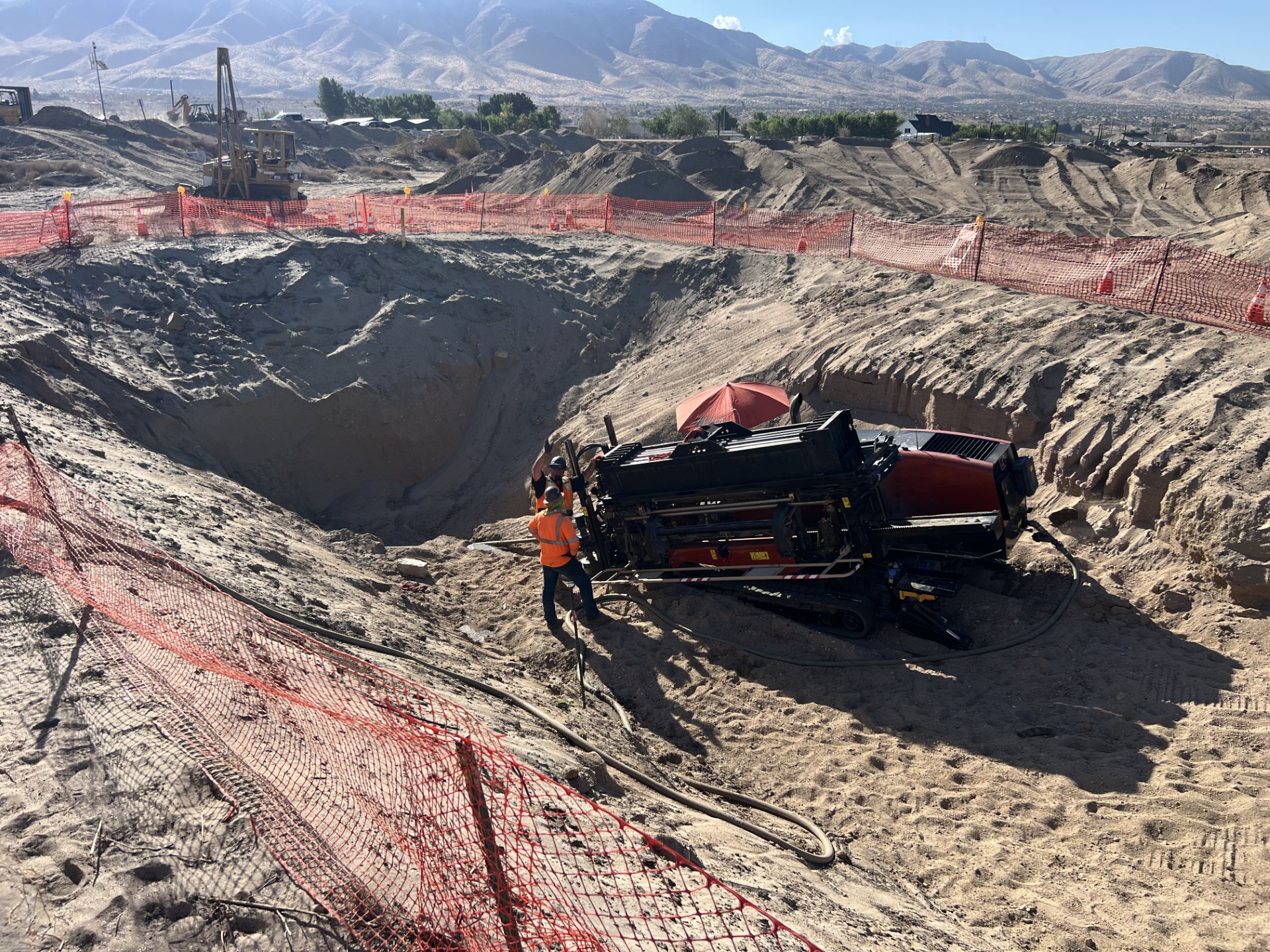 Horizontal directional drilling jobsite with Ditch Witch equipment and crew working on underground installation