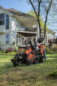 A vibratory plow performing utility trenching work in challenging ground conditions