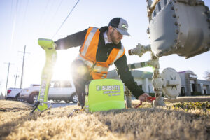 Technician using Subsite utility locating equipment to identify underground utilities before excavation work