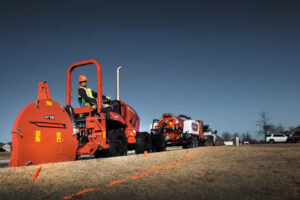Ditch Witch RT80 ride-on trencher with MT16 microtrencher attachment at an underground utility jobsite.